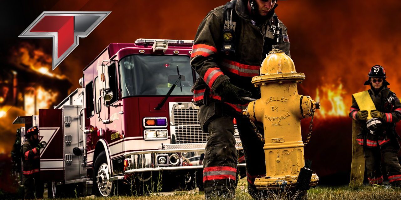 A fireman is standing next to a fire hydrant.